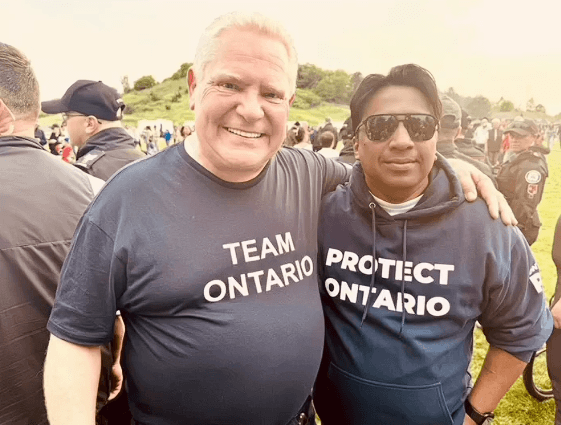 Murshed Nizam and Doug Ford wearing Team Ontario shirts at an outdoor event